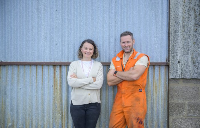 Dave Sutherland and Ruth Sutherland Knibbs standing in front of a shed door